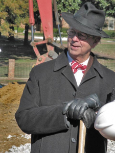 Frank Harmon with shovel on building site